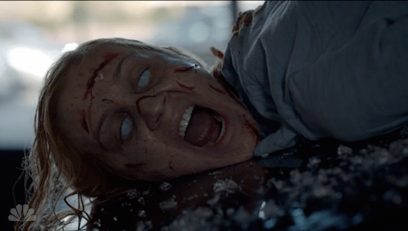 a possessed woman on a van hood